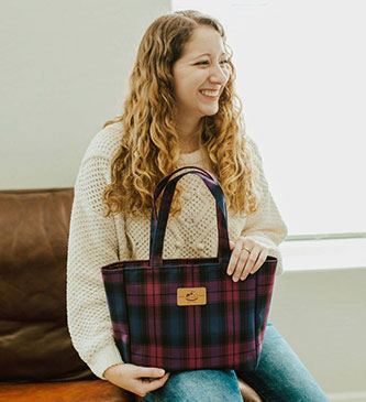  model holding one of Tworgis best-selling bags